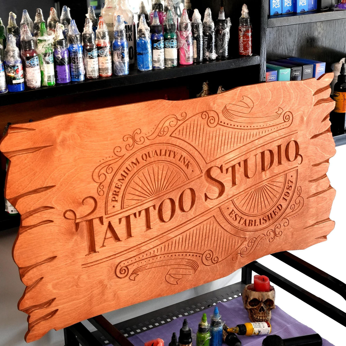 a wooden sign that says tattoo studio on it