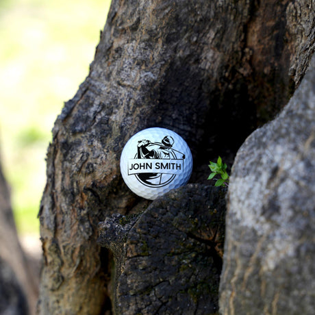 Golf ball with 'John Smith' branding embedded in a tree