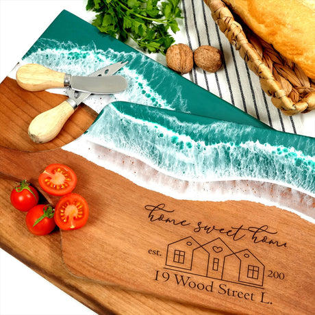 a cutting board with a knife, tomatoes and bread