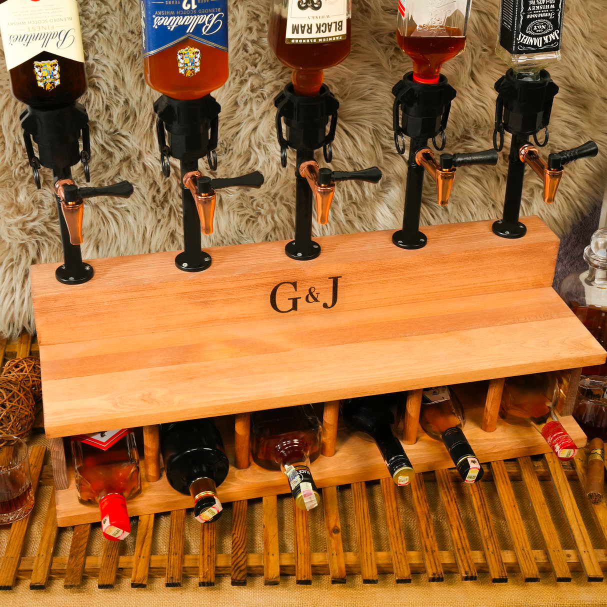 Wooden bar top with multiple bottles and taps, featuring the initials 'G&J'.