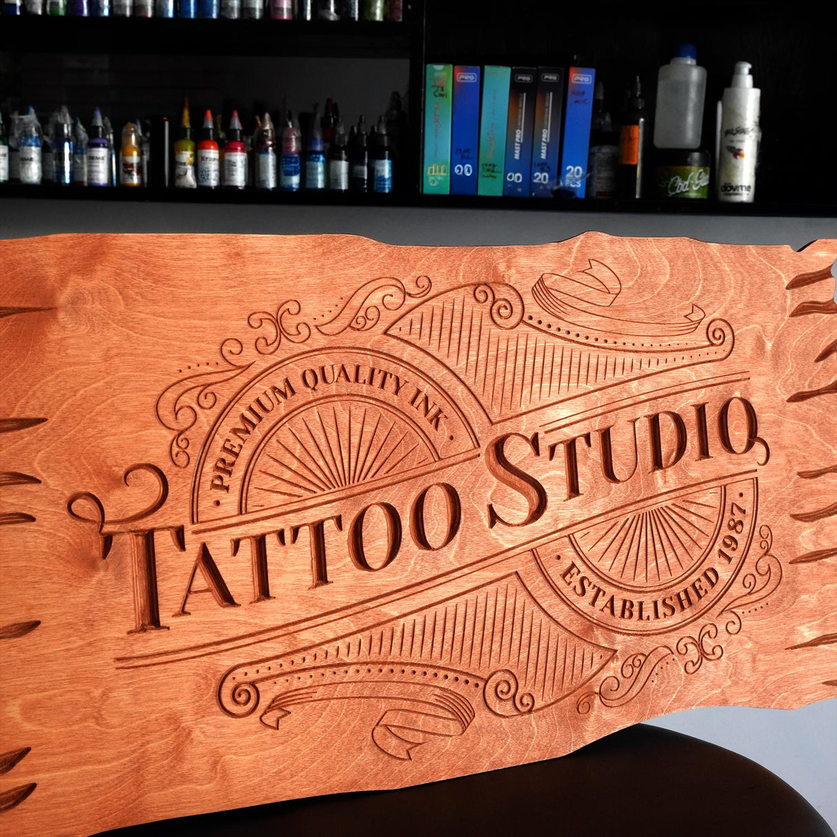 a wooden sign that says tattoo studio on it
