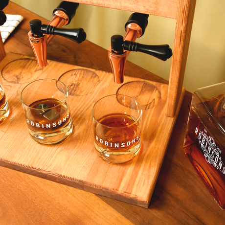 a wooden shelf with whiskey bottles and glasses