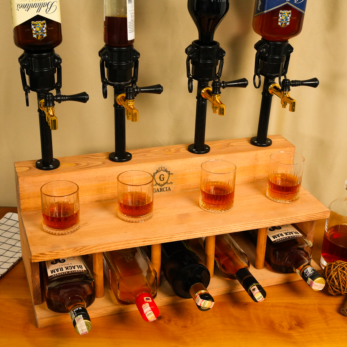 Wooden liquor dispenser set with four bottles and glasses on a wooden stand.