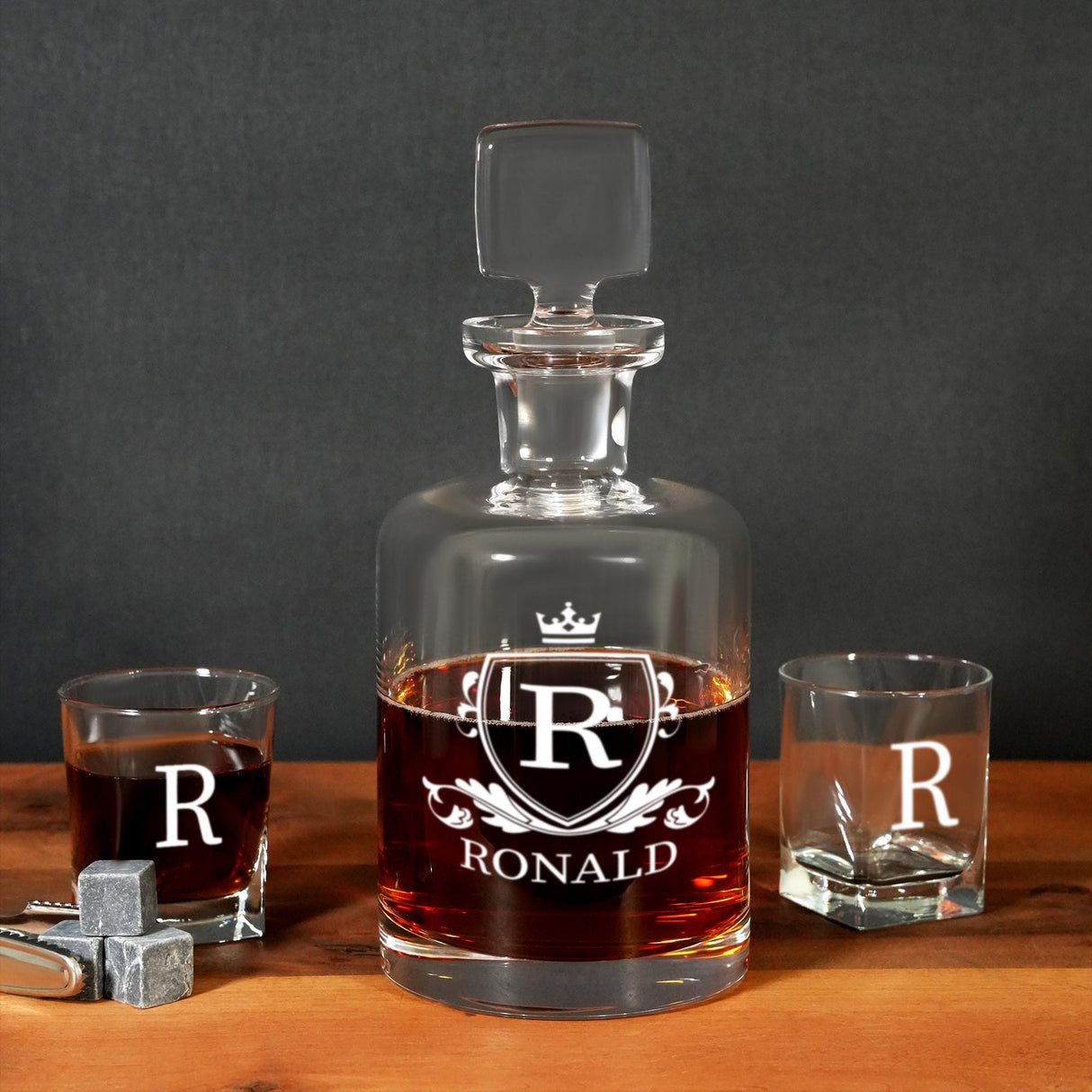 a bottle of wine and two shot glasses on a table