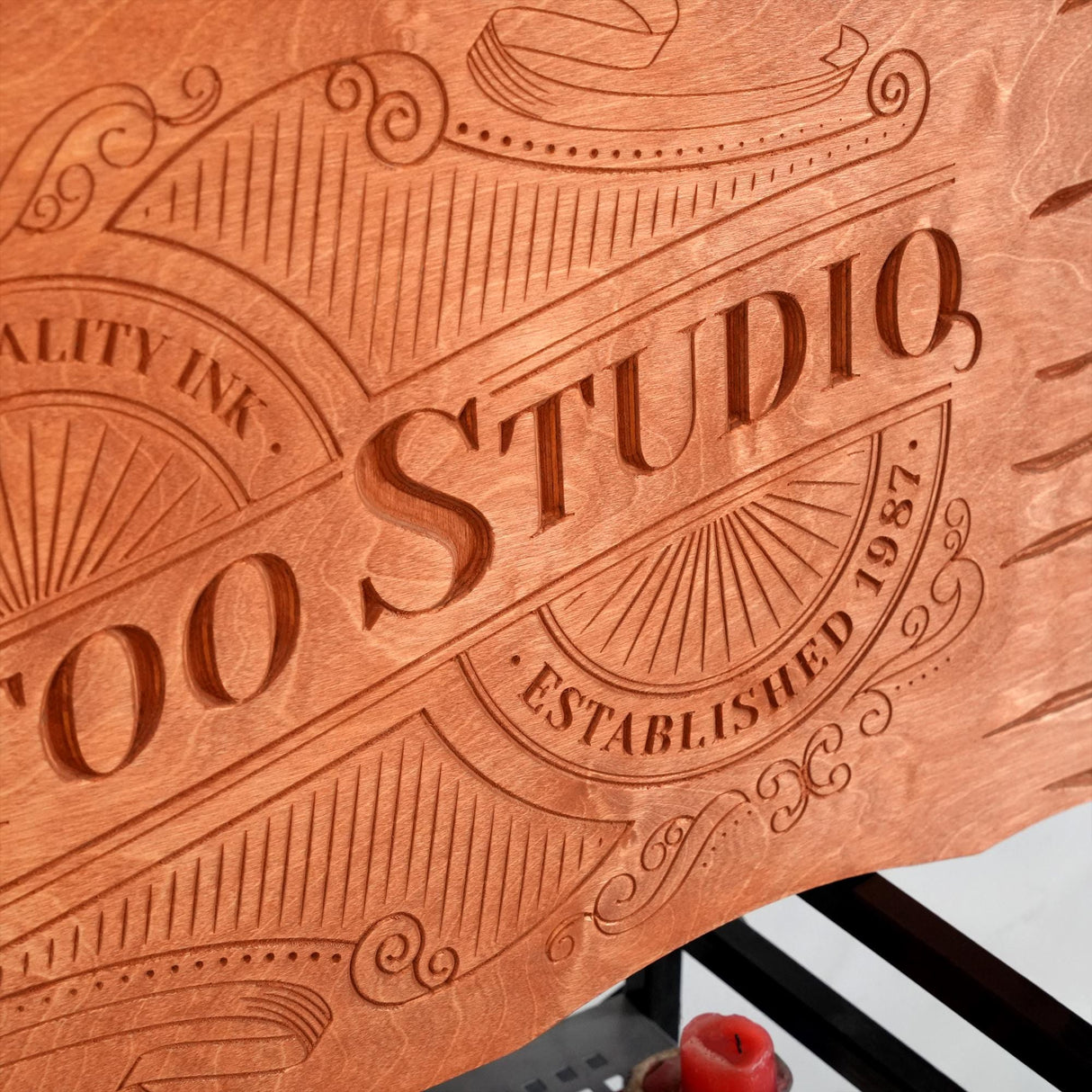 a close up of a wooden sign on a table