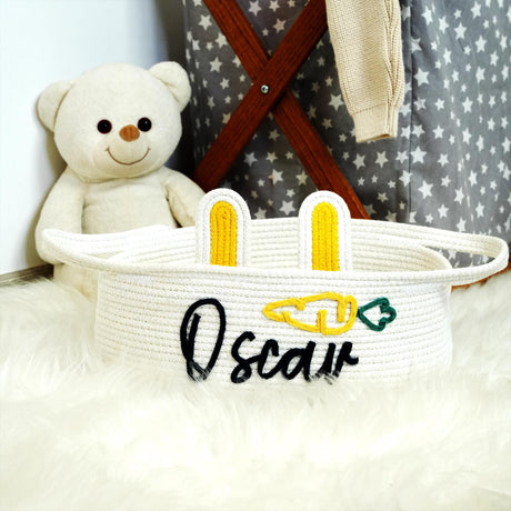 a white teddy bear sitting next to a white basket