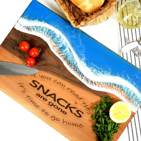a wooden cutting board with a picture of a beach