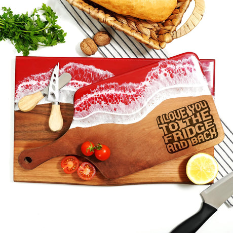 a cutting board with a knife and some tomatoes
