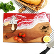 a cutting board with a knife and some tomatoes on it