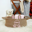 a teddy bear is sitting next to a basket