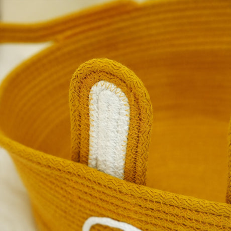 a close up of a yellow basket with handles