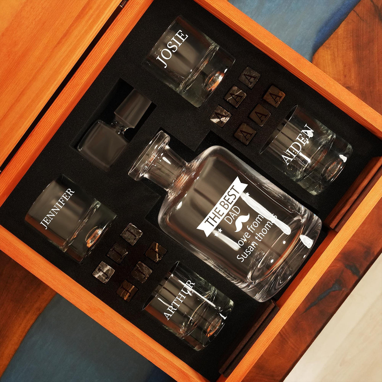 a couple of bottles of cologne sitting on top of a wooden table