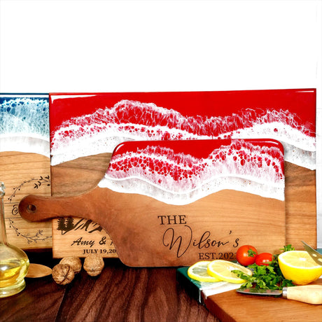 a wooden cutting board with a painting of a beach