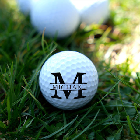 Golf ball with 'Michael' branding on grass