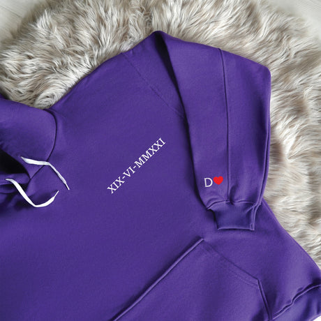 a purple hoodie laying on a furry surface