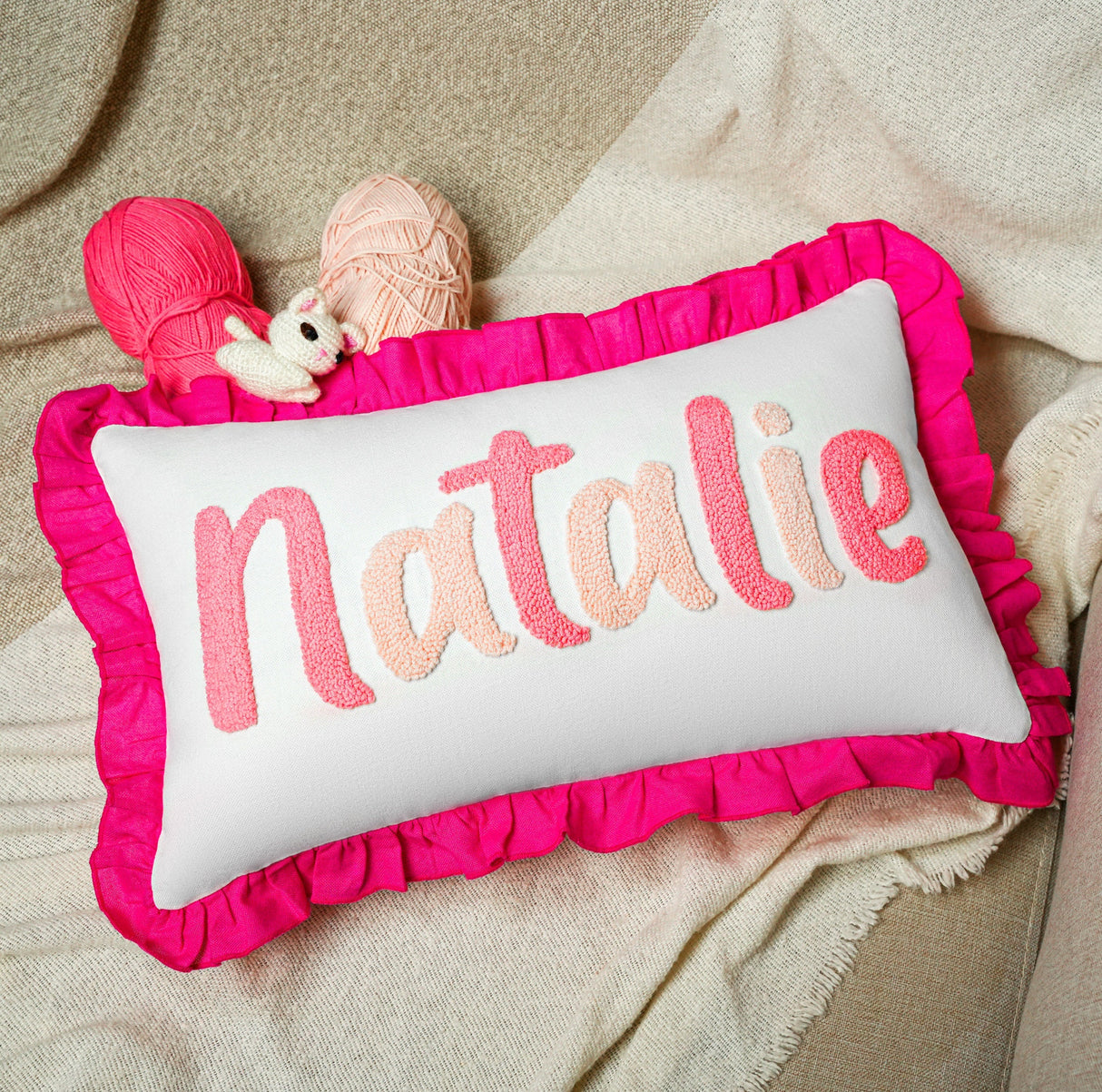 a pink pillow with the word natalie on it