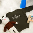 a knitted cat laying on top of a white rug