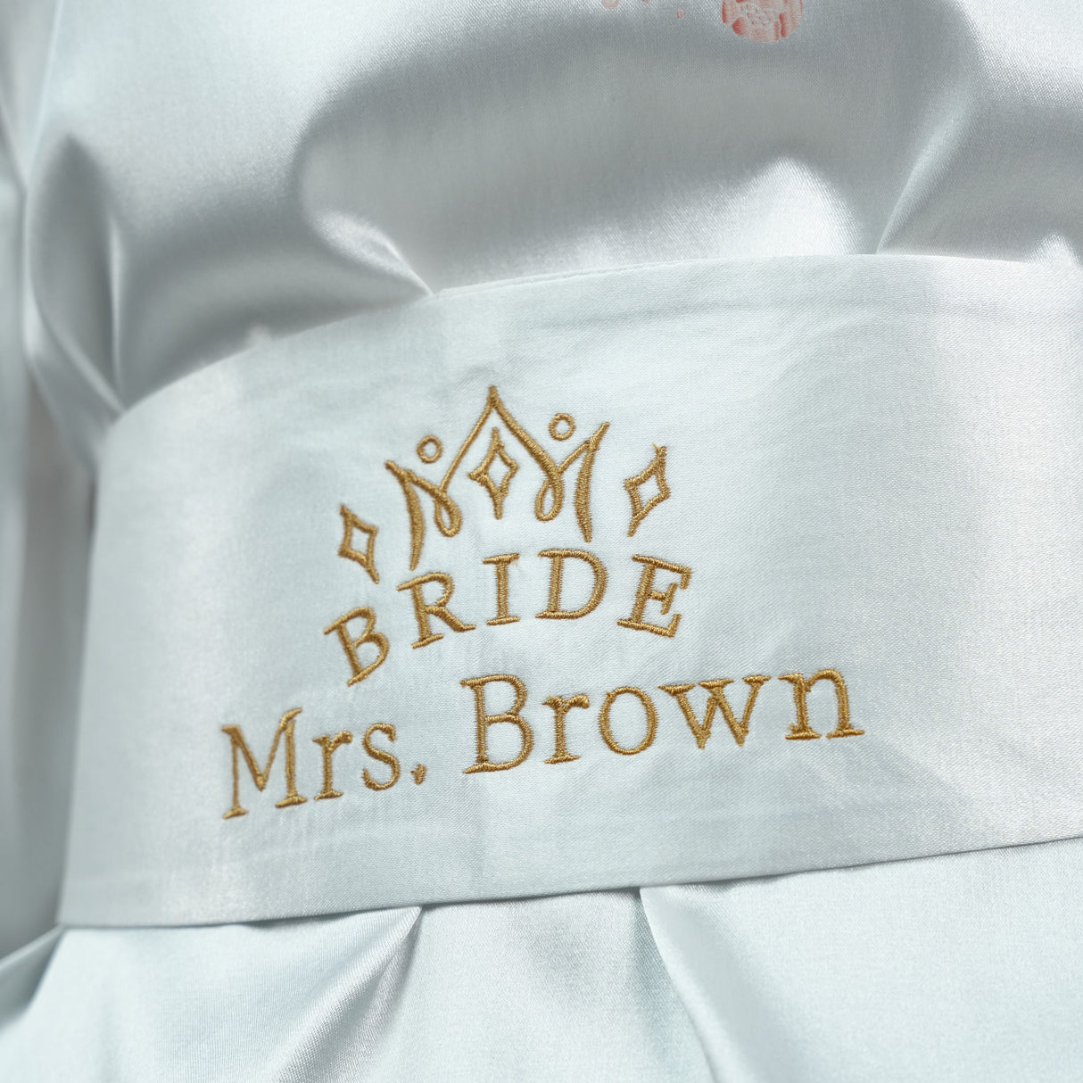 a close up of a bride's dress with a name on it