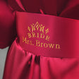 a close up of a bride's name on a red dress