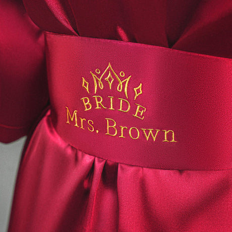 a close up of a bride's name on a red dress