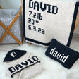 a couple of knitted items sitting on top of a white rug