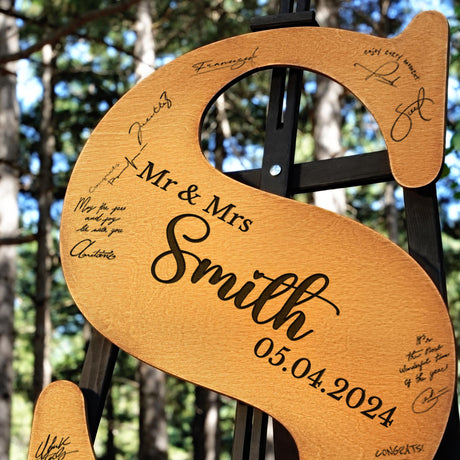 a wooden sign with a couple's names on it