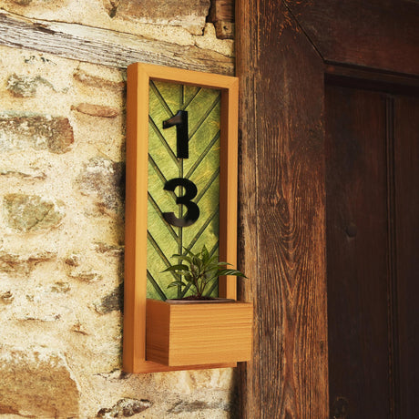 a clock with a plant in it on a wall