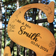 a wooden sign with a couple's names on it