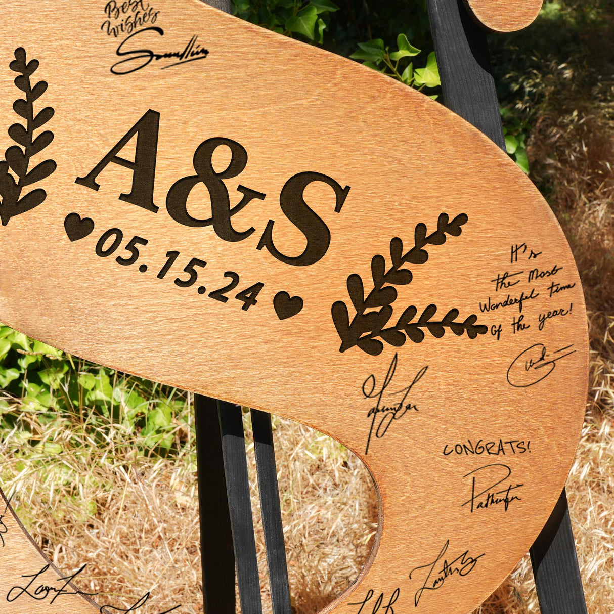 a wooden sign with a couple's names on it