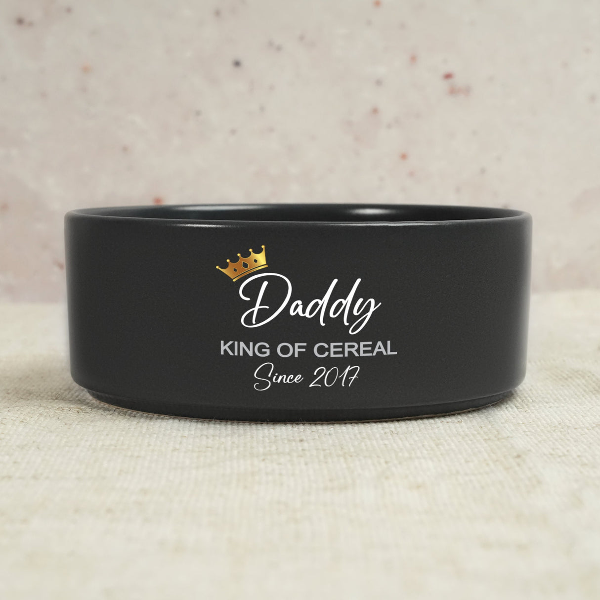 a black bowl with a crown on top of it