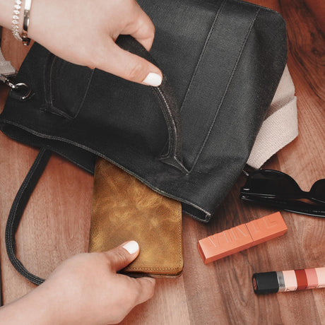 a woman's hand is opening a purse