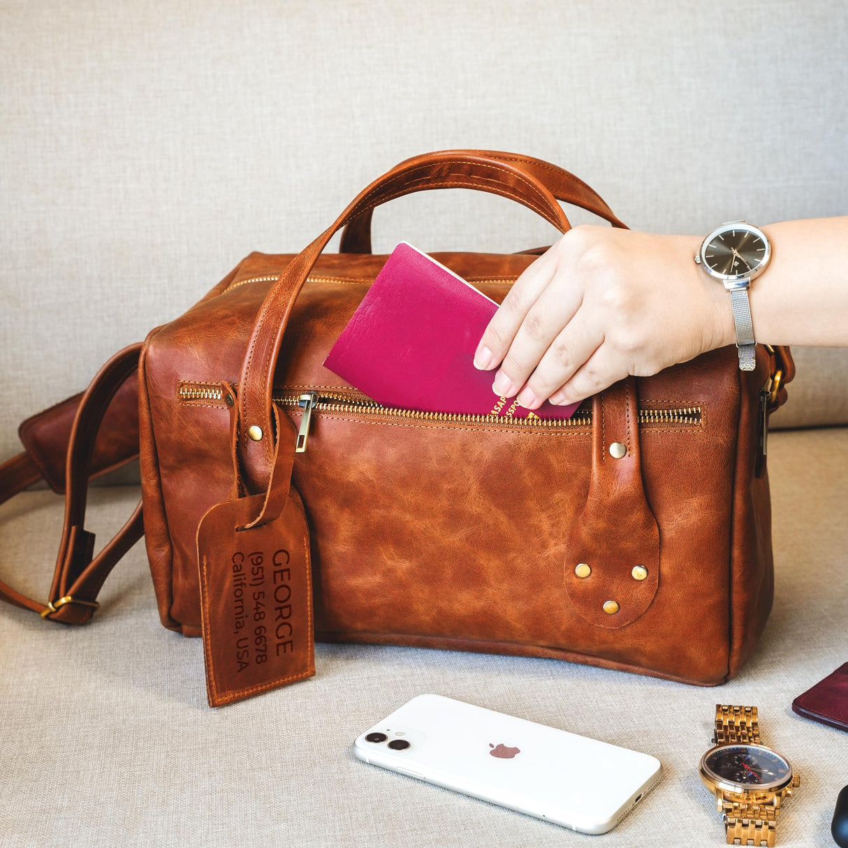 a woman's hand is holding a wallet and a purse