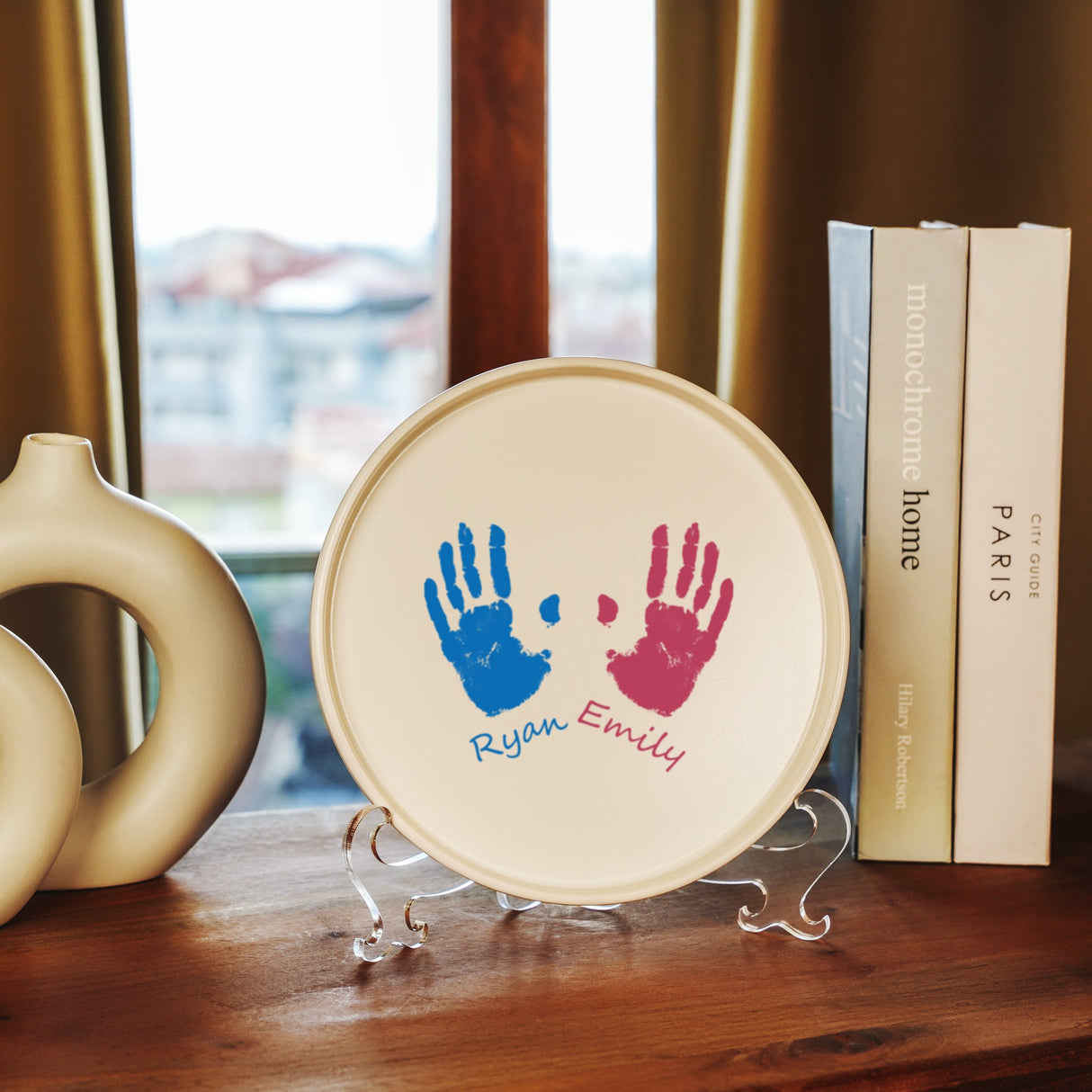 a plate with a hand print on it next to a book