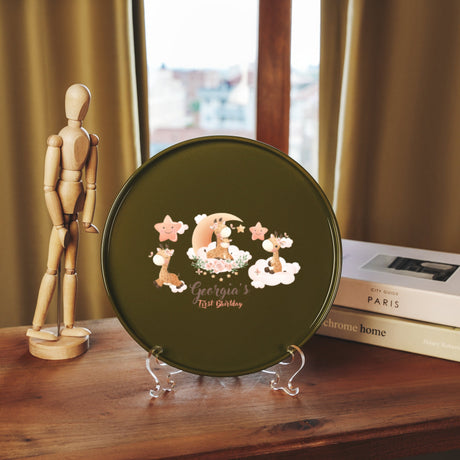 a wooden mannequin next to a green plate with a picture of a baby