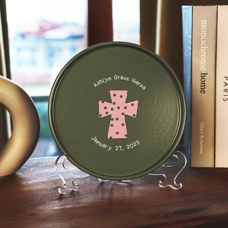 a green plate with a pink cross on it