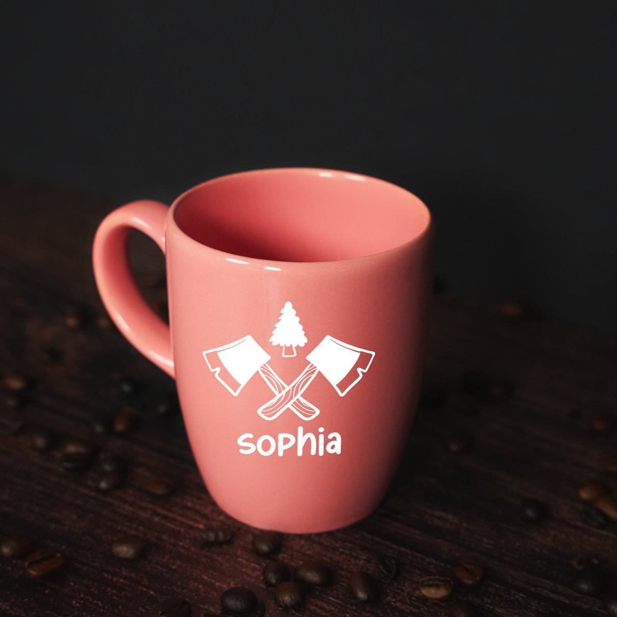 a pink coffee mug sitting on top of a wooden table