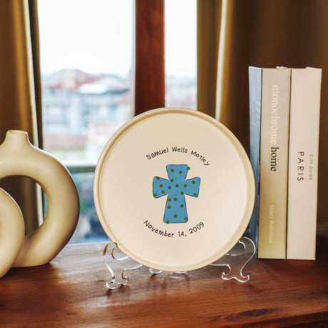 a plate with a blue cross on it sitting on a table next to a book