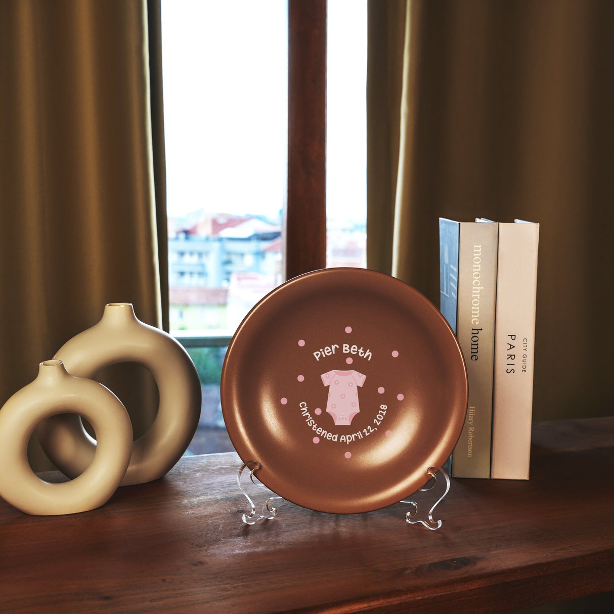 a brown plate sitting on top of a wooden table next to a book