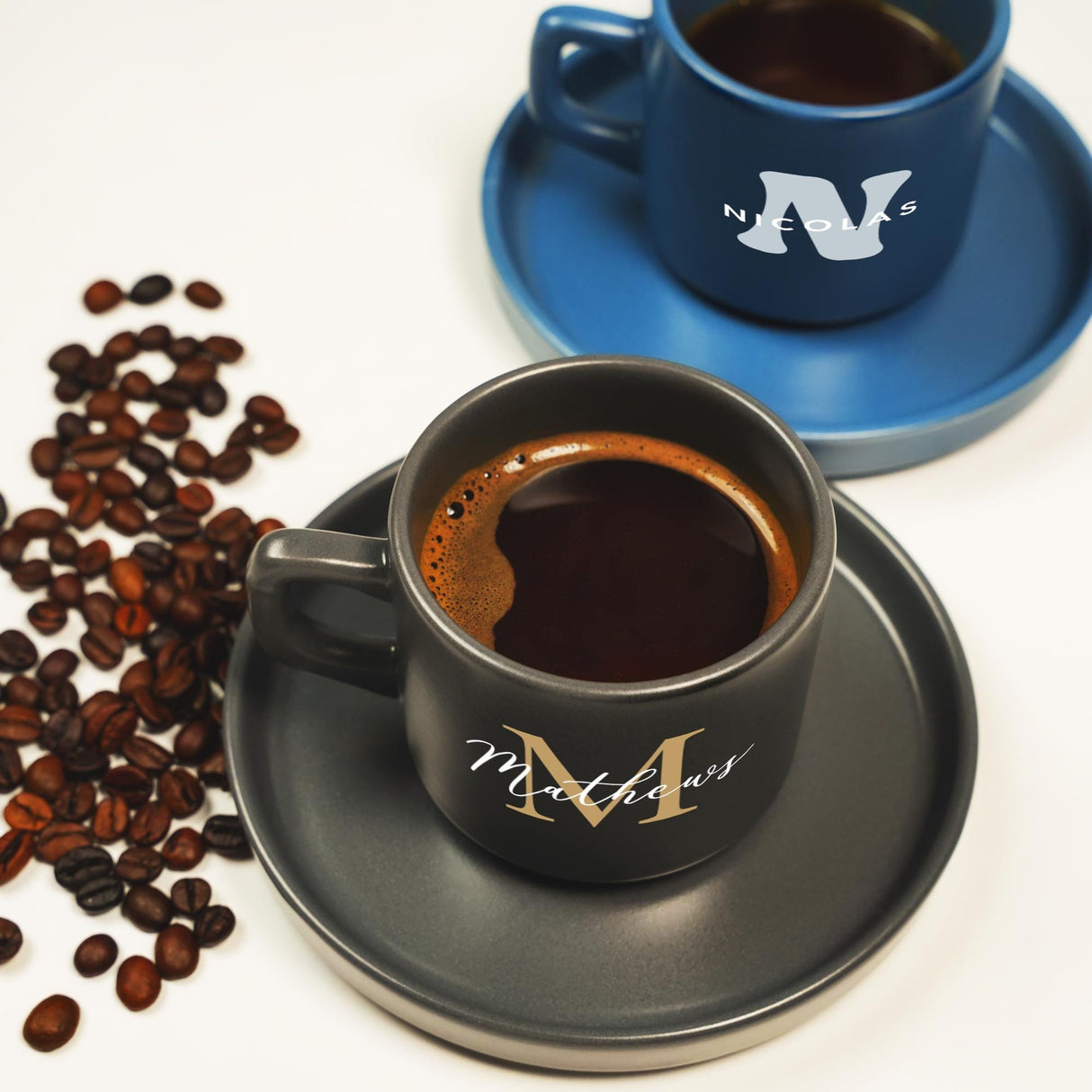 a cup of coffee next to a plate of coffee beans