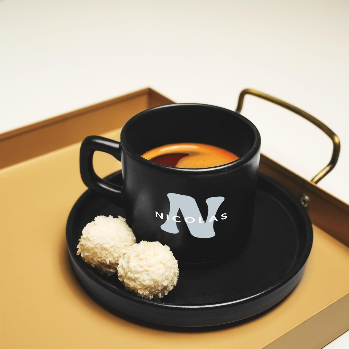 a cup of tea and a biscuit on a tray