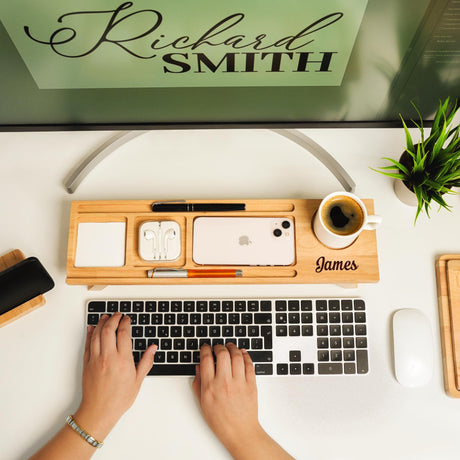 a person is typing on a keyboard on a desk