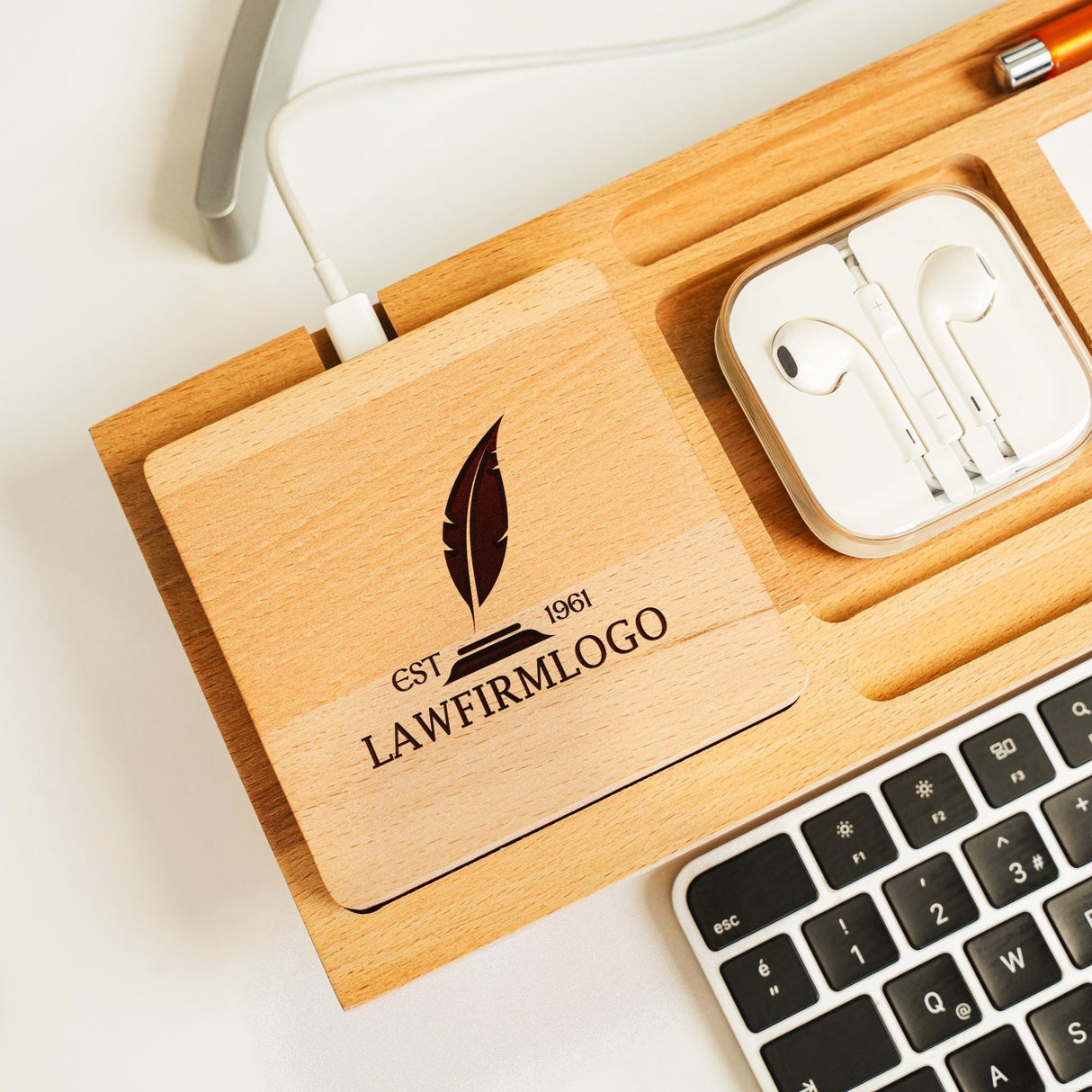 a wooden box with ear buds and a keyboard