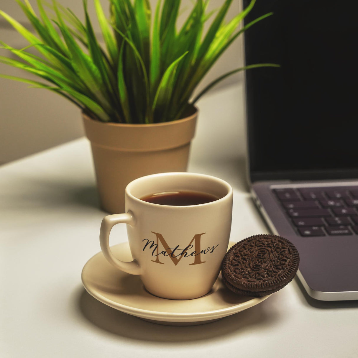 a cup of coffee and a cookie on a saucer