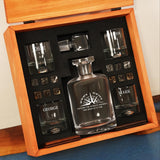 a wooden box with a bottle and glasses inside of it