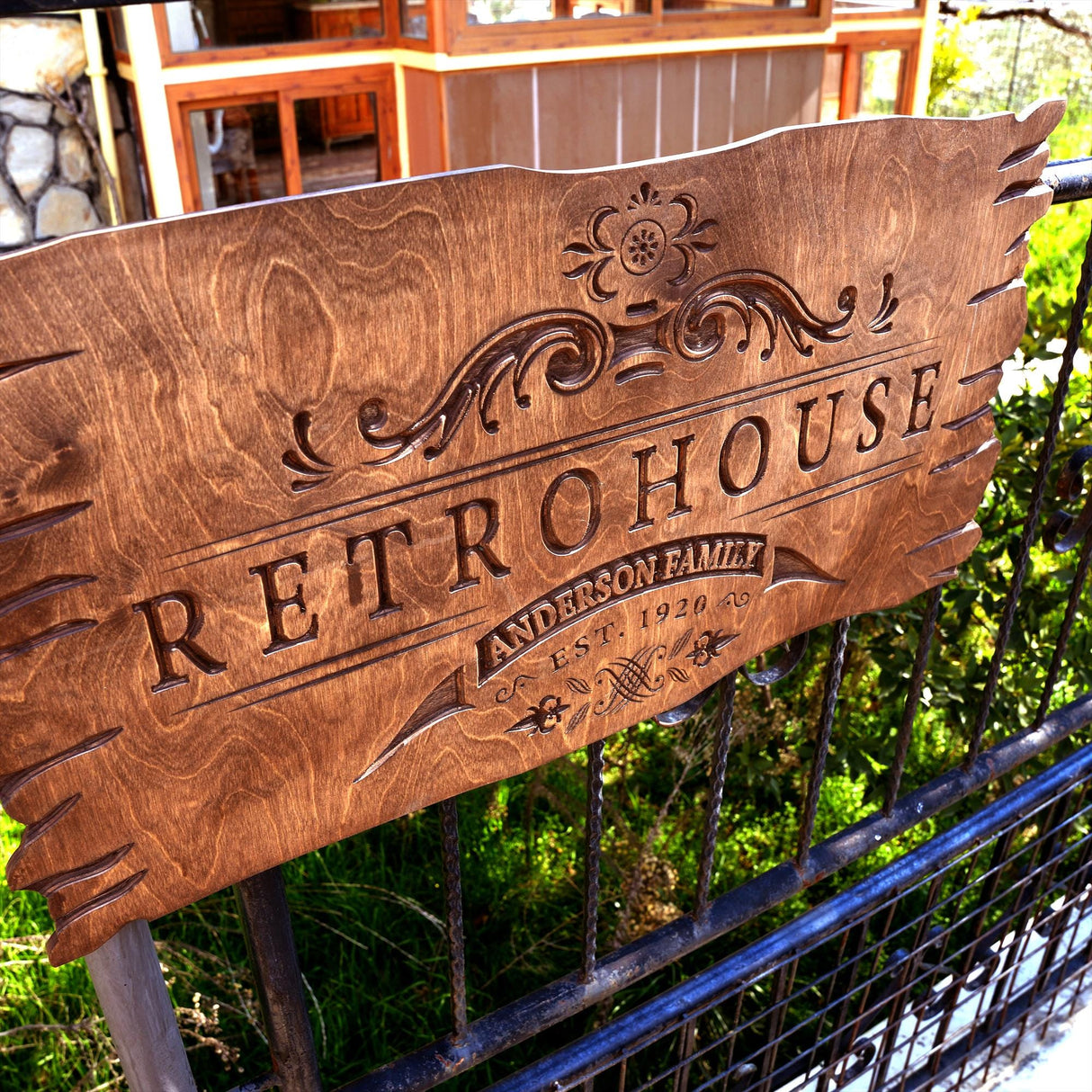 a wooden sign sitting on top of a metal fence