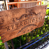 a wooden sign sitting on top of a metal fence