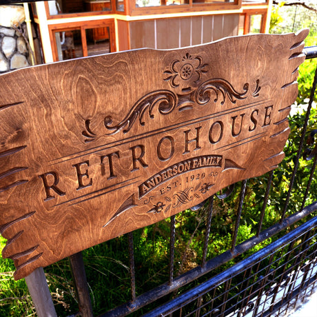 a wooden sign sitting on top of a metal fence