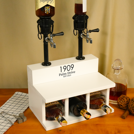 Beverage dispenser with bottles underneath on a wooden surface.