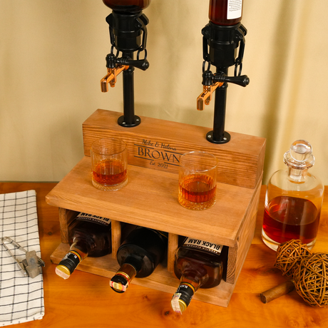 Wooden liquor dispenser with bottles and glasses on a wooden surface.