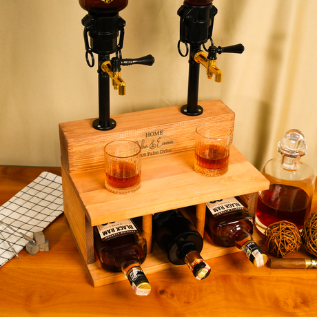 Wooden drink dispenser with bottles and glasses on a wooden surface